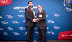 Luigi Wewege, Caye's SVP receiving Best Private Bank in Belize award from GFM publisher Joseph D. Giarraputo at Harvard Club 