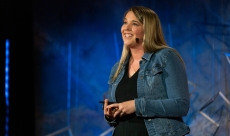 Sydney Jensen speaking on the TED stage in New York City